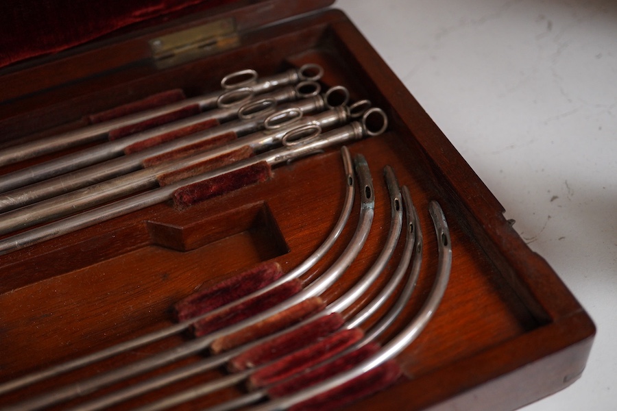 A mid 19th century mahogany cased medical set of catheter surgical instruments, inset plate to the lid engraved with ‘Wimbledon 1865. T. Wright, RHR’, 33cm wide. Condition - fair to good.